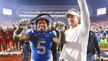 Nov 15, 2025; Oxford, Mississippi, USA; Mississippi Rebels running back Kewan Lacy (5) and head coach Lane Kiffin react after defeating the Florida Gators at Vaught-Hemingway Stadium. Mandatory Credit: Petre Thomas-Imagn Images