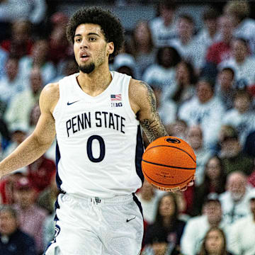 Penn State basketball guard Jahvin Carter dribbles the ball during a Nittany Lions game.