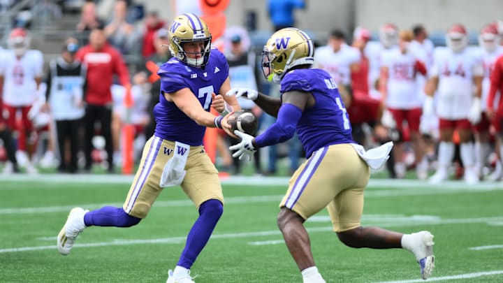 Sep 14, 2024; Seattle, Washington, USA; Washington Huskies quarterback Will Rogers (7) hands the ball off to Washington Huskies running back Jonah Coleman (1) during the first half against the Washington State Cougars at Lumen Field. Mandatory Credit: Steven Bisig-Imagn Images