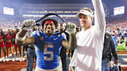 Nov 15, 2025; Oxford, Mississippi, USA; Mississippi Rebels running back Kewan Lacy (5) and head coach Lane Kiffin react after defeating the Florida Gators at Vaught-Hemingway Stadium. Mandatory Credit: Petre Thomas-Imagn Images