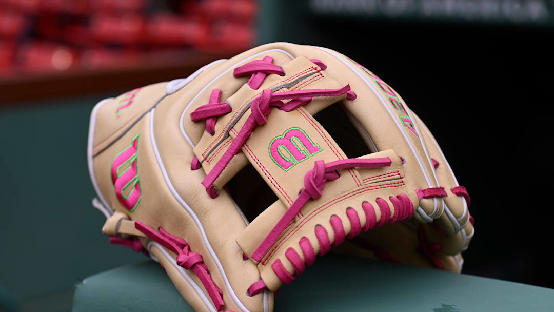 Apr 3, 2026; Boston, Massachusetts, USA; A baseball glove with pink highlights sits on the dugout railing at Fenway Park before the Boston Red Sox home opener game against the San Diego Padres. Mandatory Credit: Eric Canha-Imagn Images