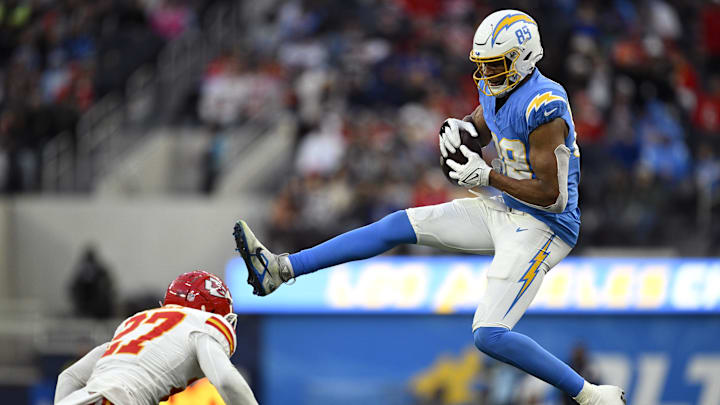 Jan 7, 2024; Inglewood, California, USA; Los Angeles Chargers tight end Donald Parham Jr. (89) makes a catch over Kansas City Chiefs safety Chamarri Conner (27) during the second half at SoFi Stadium. Mandatory Credit: Orlando Ramirez-Imagn Images