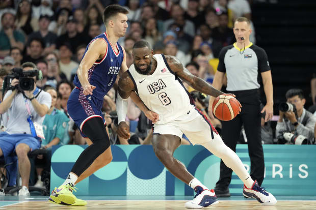 USA forward LeBron James dribbles to the basket against Serbia.