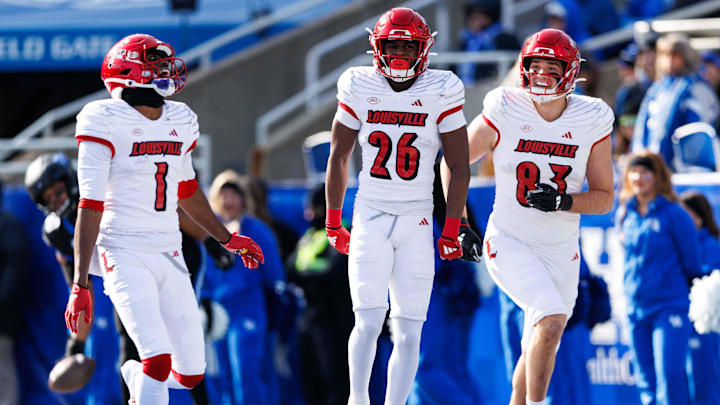 Nov 30, 2024; Lexington, Kentucky, USA; Louisville Cardinals running back Duke Watson (26) celebrates a touchdown with wide receiver Ja'Corey Brooks (1) and tight end Mark Redman (83) during the second quarter against the Kentucky Wildcats at Kroger Field. Mandatory Credit: Jordan Prather-Imagn Images Nov 30, 2024; Lexington, Kentucky, USA; Louisville Cardinals running back Duke Watson (26) celebrates a touchdown with wide receiver Ja'Corey Brooks (1) and tight end Mark Redman (83) during the second quarter against the Kentucky Wildcats at Kroger Field. Mandatory Credit: Jordan Prather-Imagn Images