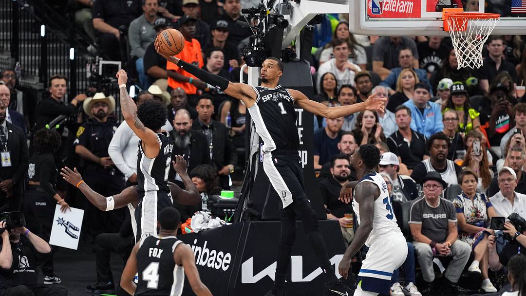May 12, 2026; San Antonio, Texas, USA; San Antonio Spurs forward Victor Wembanyama (1) reaches for a rebound over Minnesota Timberwolves forward Julius Randle (30) during the second half of game five of the second round of the 2026 NBA Playoffs at Frost Bank Center. Mandatory Credit: Scott Wachter-Imagn Images