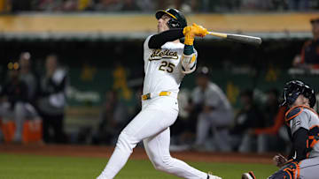 Sep 6, 2024; Oakland, California, USA; Oakland Athletics designated hitter Brent Rooker (25) hits an RBI sacrifice fly against the Detroit Tigers during the twelfth inning at Oakland-Alameda County Coliseum. Mandatory Credit: Darren Yamashita-Imagn Images