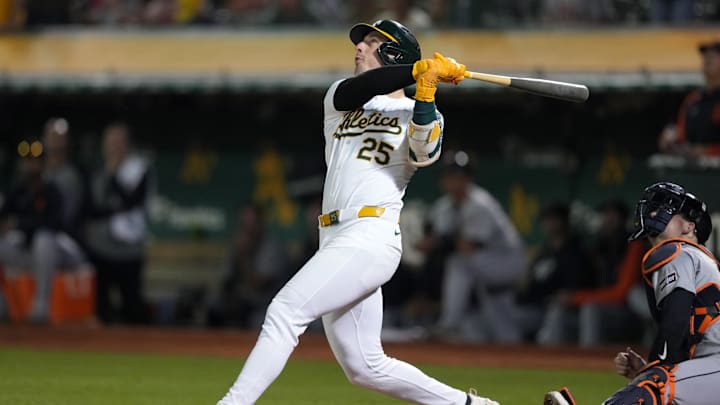 Sep 6, 2024; Oakland, California, USA; Oakland Athletics designated hitter Brent Rooker (25) hits an RBI sacrifice fly against the Detroit Tigers during the twelfth inning at Oakland-Alameda County Coliseum. Mandatory Credit: Darren Yamashita-Imagn Images