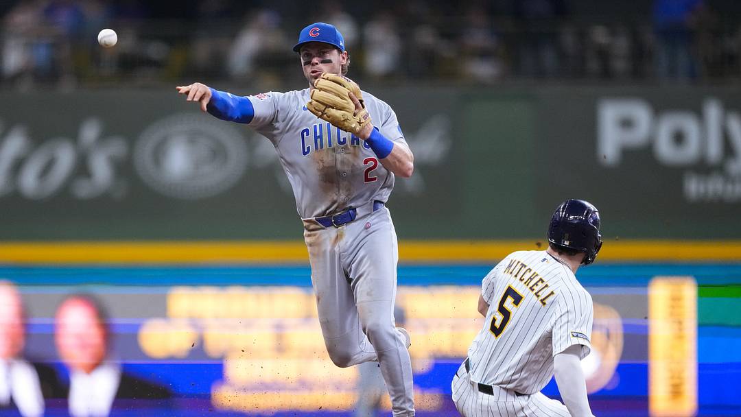 Chicago Cubs second baseman Nico Hoerner turns a double play against the Milwaukee Brewers.