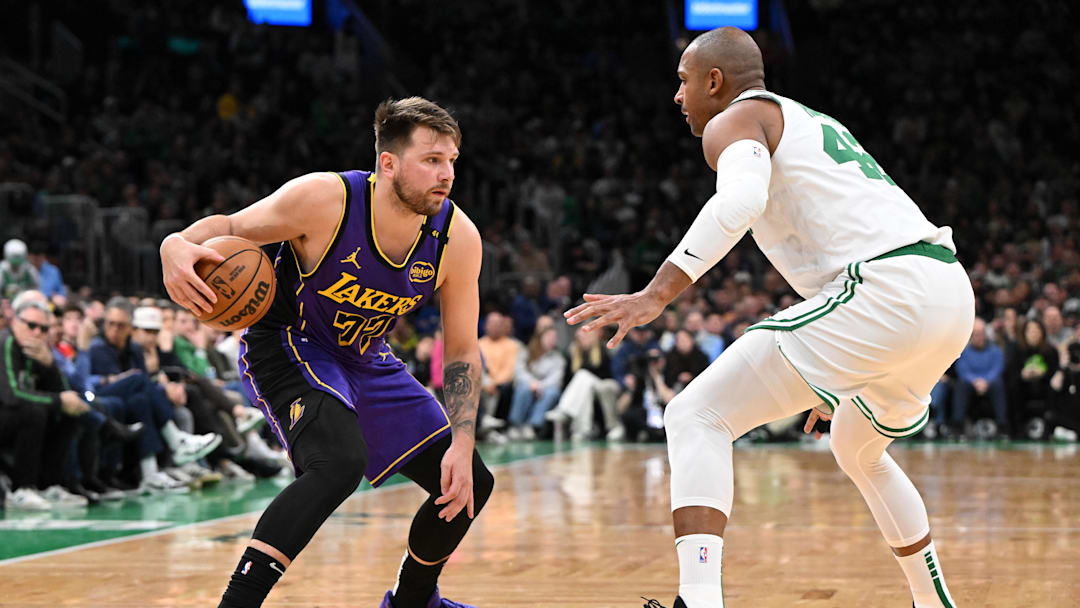 Mar 8, 2025; Boston, Massachusetts, USA; Los Angeles Lakers guard Luka Doncic (77) drives to the basket against Boston Celtics center Al Horford (42) during the second quarter at the TD Garden. Mandatory Credit: Brian Fluharty-Imagn Images