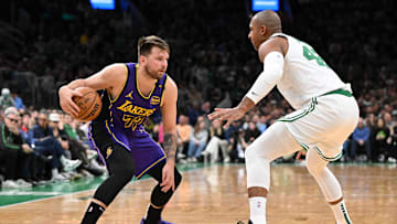 Mar 8, 2025; Boston, Massachusetts, USA; Los Angeles Lakers guard Luka Doncic (77) drives to the basket against Boston Celtics center Al Horford (42) during the second quarter at the TD Garden. Mandatory Credit: Brian Fluharty-Imagn Images