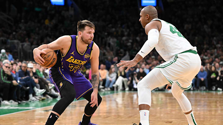 Mar 8, 2025; Boston, Massachusetts, USA; Los Angeles Lakers guard Luka Doncic (77) drives to the basket against Boston Celtics center Al Horford (42) during the second quarter at the TD Garden. Mandatory Credit: Brian Fluharty-Imagn Images