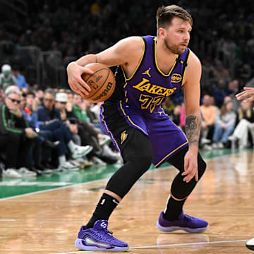 Mar 8, 2025; Boston, Massachusetts, USA; Los Angeles Lakers guard Luka Doncic (77) drives to the basket against Boston Celtics center Al Horford (42) during the second quarter at the TD Garden.