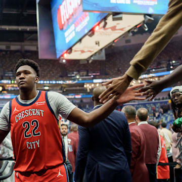 Nov 4, 2025; New Orleans, Louisiana, USA; New Orleans Pelicans center Derik Queen (22) celebrates with fans at the end of the game against the Charlotte Hornets at Smoothie King Center. Mandatory Credit: Matthew Hinton-Imagn Images
