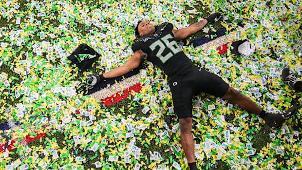 Oregon Ducks linebacker Devon Jackson (26) makes a confetti angel on Sunday, Dec. 8, 2024, after the Big Ten Championship 