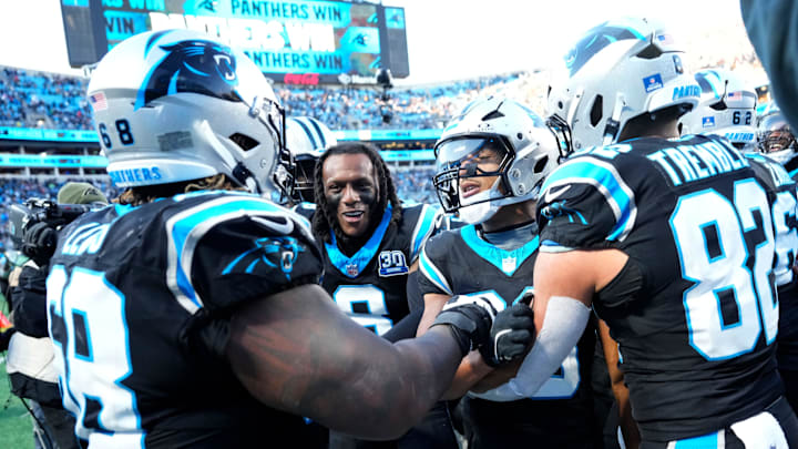 Carolina Panthers RB Chuba Hubbard celebrates with G Damien Lewis, CB Jaycee Horn, and TE Tommy Tremble