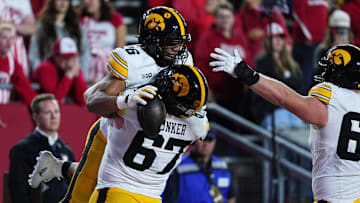Oct 11, 2025; Madison, Wisconsin, USA; Iowa Hawkeyes running back Xavier Williams (26) celebrates a touchdown with teammate offensive lineman Gennings Dunker (67) during the second half against the Wisconsin Badgers at Camp Randall Stadium. Mandatory Credit: Ross Harried-Imagn Images