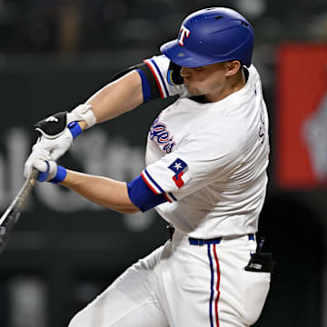 Aug 11, 2025; Arlington, Texas, USA; Texas Rangers shortstop Corey Seager (5) hits a double and drives in a run against the Arizona Diamondbacks during the third inning at Globe Life Field. 