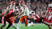 Nov 22, 2025; Madison, Wisconsin, USA; Illinois Fighting Illini quarterback Luke Altmyer (9) runs the ball against Wisconsin Badgers cornerback Ricardo Hallman, left, and Wisconsin Badgers linebacker Aaron Witt (59) during the first quarter at Camp Randall Stadium. Mandatory Credit: Kayla Wolf-Imagn Images