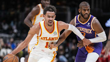 Feb 3, 2022; Atlanta, Georgia, USA; Phoenix Suns guard Chris Paul (3) tries to defend Atlanta Hawks guard Trae Young (11) during the first half at State Farm Arena. Mandatory Credit: Dale Zanine-Imagn Images