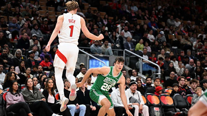 Oct 10, 2025; Toronto, Ontario, CAN;   Boston Celtics forward Hugo González (28) draws Toronto Raptors forward Gradey Dick (1) out of position in the first half at Scotiabank Arena. Mandatory Credit: Dan Hamilton-Imagn Images
