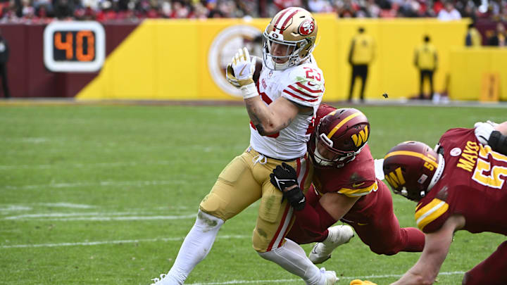 Dec 31, 2023; Landover, Maryland, USA; San Francisco 49ers running back Christian McCaffrey (23) is tackled by Washington Commanders linebacker Cody Barton (57)  during the second half at FedExField. Mandatory Credit: Brad Mills-Imagn Images