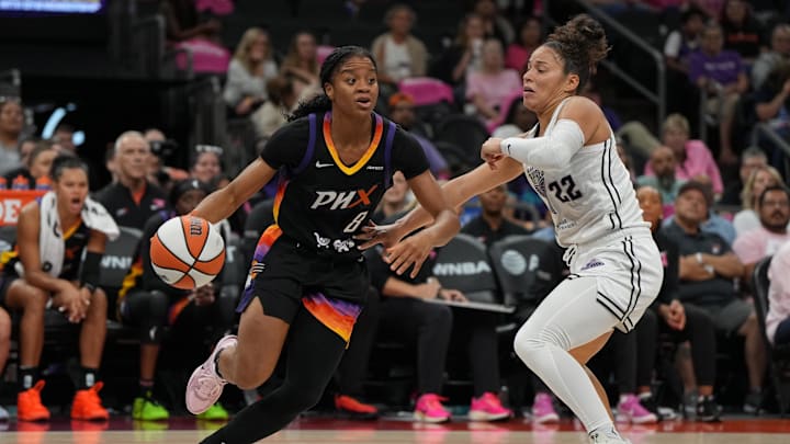 Aug 22, 2025; Phoenix, Arizona, USA; Phoenix Mercury guard Monique Akoa Makani (8) drives on Golden State Valkyries guard Veronica Burton (22) in the second half at Footprint Center. Mandatory Credit: Rick Scuteri-Imagn Images
