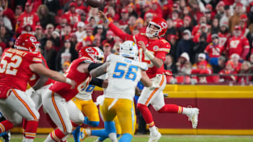 Kansas City Chiefs quarterback Patrick Mahomes passes as Los Angeles Chargers defender Morgan Fox rushes during an NFL game