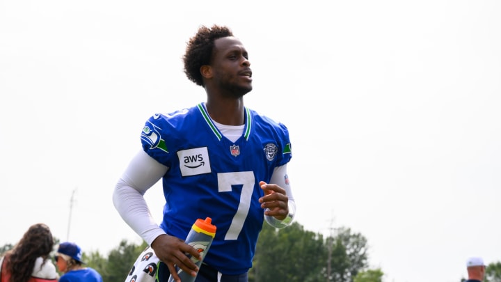 Jul 27, 2024; Renton, WA, USA; Seattle Seahawks quarterback Geno Smith (7) jogs off the field after training camp at Virginia Mason Athletic Center. Mandatory Credit: Steven Bisig-USA TODAY Sports