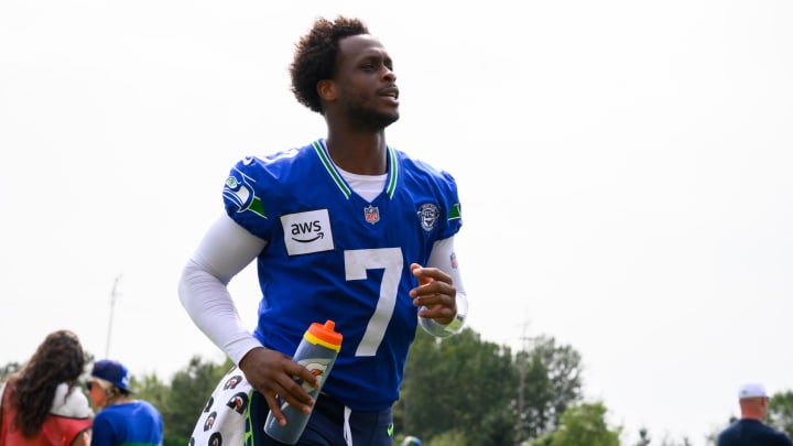 Jul 27, 2024; Renton, WA, USA; Seattle Seahawks quarterback Geno Smith (7) jogs off the field after training camp at Virginia Mason Athletic Center. Mandatory Credit: Steven Bisig-USA TODAY Sports