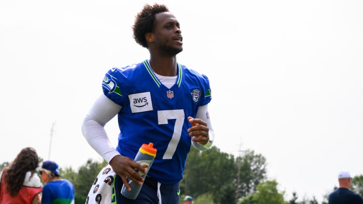 Jul 27, 2024; Renton, WA, USA; Seattle Seahawks quarterback Geno Smith (7) jogs off the field after training camp at Virginia Mason Athletic Center. Mandatory Credit: Steven Bisig-USA TODAY Sports