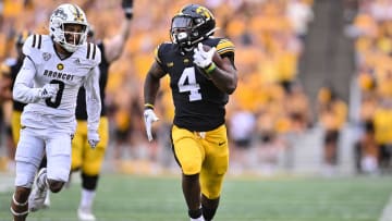 Sep 16, 2023; Iowa City, Iowa, USA; Iowa Hawkeyes running back Leshon Williams (4) runs the ball as Western Michigan Broncos cornerback DaShon Bussell (0) moves in for the tackle during the second quarter at Kinnick Stadium. Mandatory Credit: Jeffrey Becker-USA TODAY Sports