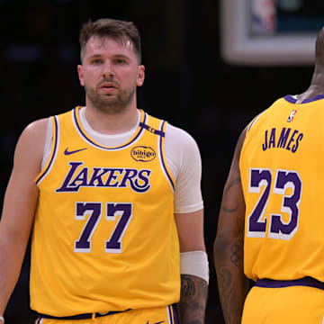 Feb 10, 2025; Los Angeles, California, USA; Los Angeles Lakers guard Luka Doncic (77) and forward LeBron James (23) on the court in the first half against the Utah Jazz at Crypto.com Arena. Mandatory Credit: Jayne Kamin-Oncea-Imagn Images