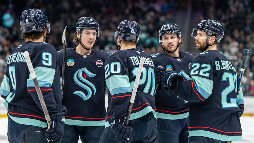 Feb 6, 2025; Seattle, Washington, USA;  Seattle Kraken, from left, forward Chandler Stephenson (9), defenseman Cale Fleury (8), forward Eeli Tolvanen (20), defenseman Brandon Montour (62) and forward Oliver Bjorkstrand (22) celebrate a goal during the third period against the Toronto Maple Leafs at Climate Pledge Arena. Mandatory Credit: Stephen Brashear-Imagn Images