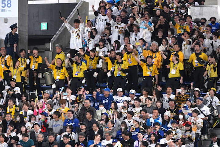 Hanshin Tigers fans cheer after a strikeout by Los Angeles Dodgers designated hitter Shohei Ohtani.