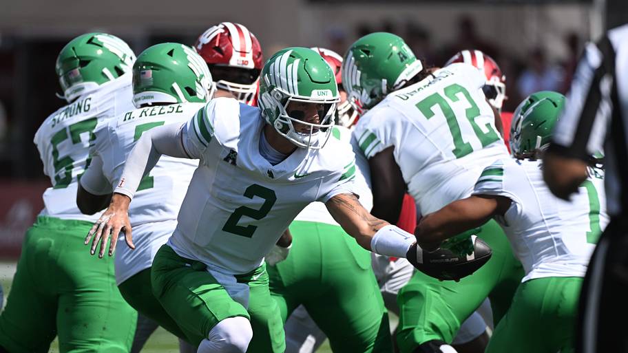 North Texas Mean Green quarterback Tayven Jackson hands off against the Indiana Hoosiers.