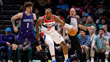 Mar 1, 2025; Charlotte, North Carolina, USA; Washington Wizards forward Khris Middleton (32) backs down Charlotte Hornets guard LaMelo Ball (1) during the first quarter at Spectrum Center. Mandatory Credit: Scott Kinser-Imagn Images