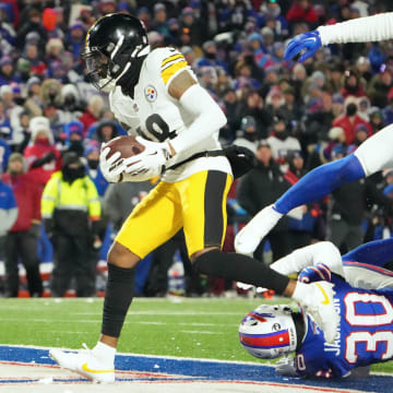 Jan 15, 2024; Orchard Park, New York, USA; Pittsburgh Steelers wide receiver Diontae Johnson (18) runs the ball in for a touch-down in the first half against the Buffalo Bills in a 2024 AFC wild card game at Highmark Stadium. Mandatory Credit: Kirby Lee-USA TODAY Sports