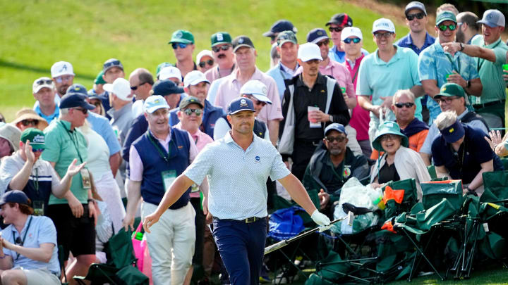 Apr 12, 2024; Augusta, Georgia, USA; Bryson DeChambeau reacts after hitting out of the gallery on