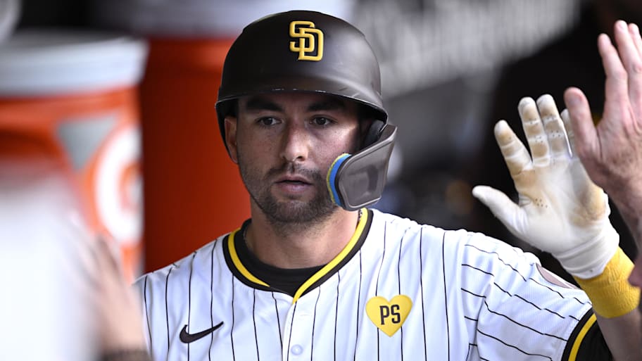 Padres catcher Kyle Higashioka is congratulated in the dugout