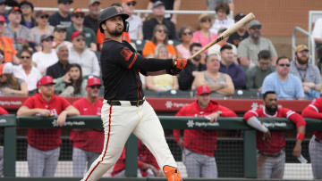 Feb 26, 2024; Scottsdale, Arizona, USA; San Francisco Giants third baseman JD Davis (7) hits against the Los Angeles Angels in the first inning at Scottsdale Stadium. Mandatory Credit: Rick Scuteri-USA TODAY Sports