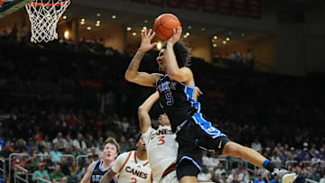Feb 25, 2025; Coral Gables, Florida, USA;  Duke basketball guard Tyrese Proctor (5) gets fouled by Miami (Fl) Hurricanes guard Jalil Bethea (3) during the first half at Watsco Center.
