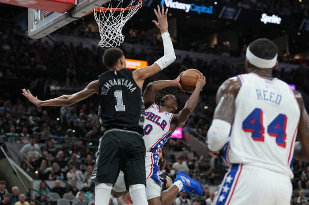 Philadelphia 76ers guard Tyrese Maxey (0) shoots against San Antonio Spurs center Victor Wembanyama (1).