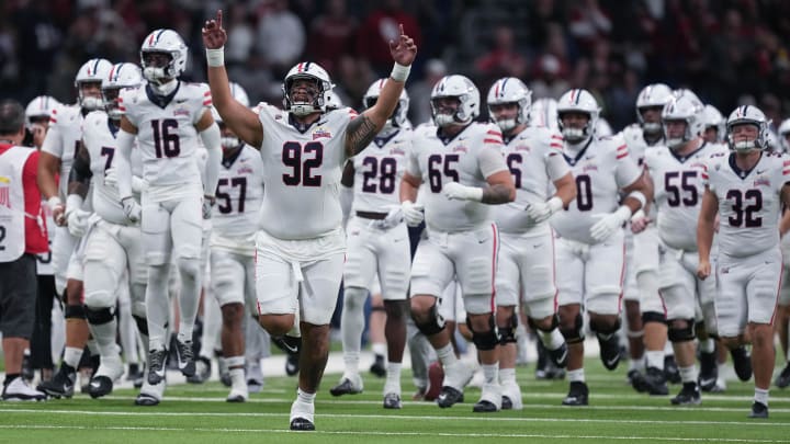 Dec 28, 2023; San Antonio, TX, USA;  Arizona Wildcats defensive lineman Tyler Manoa (92) leads the team out ahead of the game against the Oklahoma Sooners at Alamodome