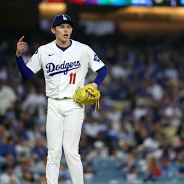 Apr 12, 2025; Los Angeles, California, USA; Los Angeles Dodgers pitcher Roki Sasaki (11) reacts after a pitch against the Chicago Cubs during the fifth inning at Dodger Stadium. Mandatory Credit: Kiyoshi Mio-Imagn Images