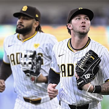 May 13, 2024; San Diego, California, USA; San Diego Padres center fielder Jackson Merrill (right) and right fielder Fernando Tatis Jr. (left) jog to the dugout during the middle of the second inning against the Colorado Rockies at Petco Park. Mandatory Credit: Orlando Ramirez-Imagn Images