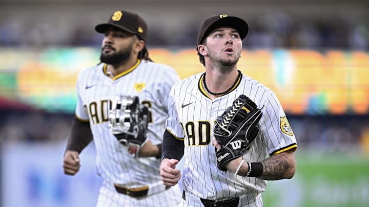 May 13, 2024; San Diego, California, USA; San Diego Padres center fielder Jackson Merrill (right) and right fielder Fernando Tatis Jr. (left) jog to the dugout during the middle of the second inning against the Colorado Rockies at Petco Park. Mandatory Credit: Orlando Ramirez-Imagn Images