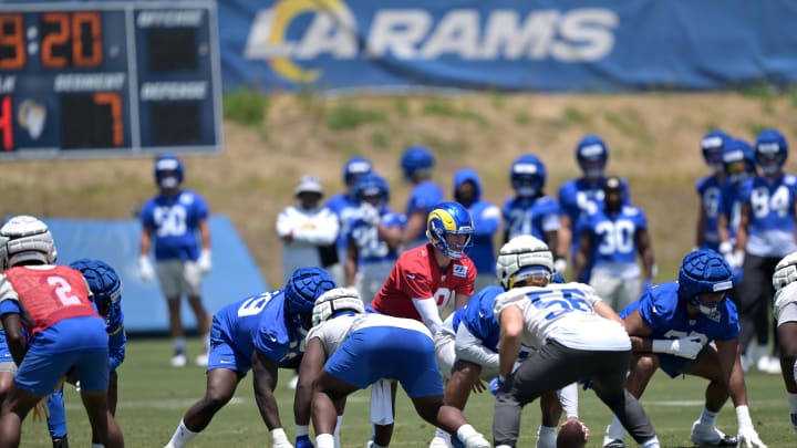 May 28, 2024; Thousand Oaks, CA, USA; Los Angeles Rams quarterback Matthew Stafford (9) takes a snap during OTAs at the team training facility at California Lutheran University. Mandatory Credit: Jayne Kamin-Oncea-USA TODAY Sports