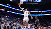 Nov 21, 2025; Salt Lake City, Utah, USA; Wisconsin Badgers guard Braeden Carrington (0) lays the ball up against BYU Cougars forward AJ Dybantsa (3) during the first half at Delta Center. 