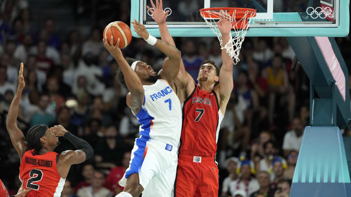 Aug 6, 2024; Paris, France; France power forward Guerschon Yabusele (7) shoots against Canada power forward Dwight Powell (7) in the first quarter in a men’s basketball quarterfinal game during the Paris 2024 Olympic Summer Games at Accor Arena. Mandatory Credit: Kyle Terada-USA TODAY Sports