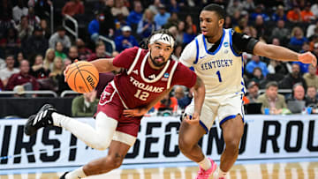 Mar 21, 2025; Milwaukee, WI, USA; Troy Trojans guard Tayton Conerway (12) drives to the hoop past Kentucky Wildcats guard Lamont Butler (1) during the second half at Fiserv Forum. Mandatory Credit: Benny Sieu-Imagn Images